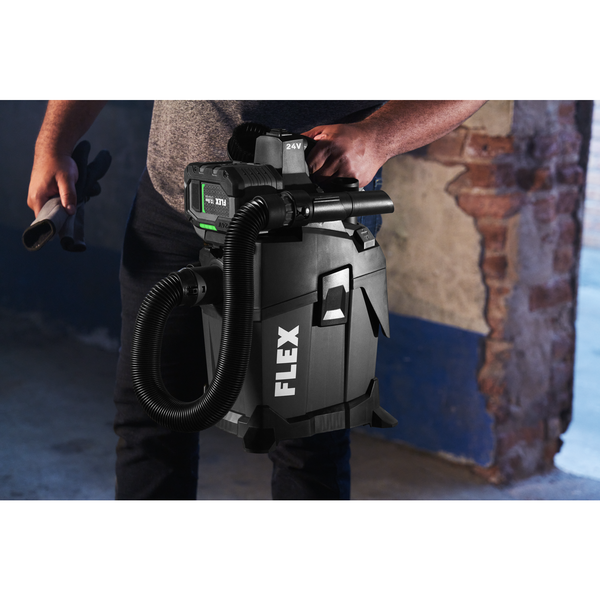 Flex Jobsite Vacuum being held up in the air by a man