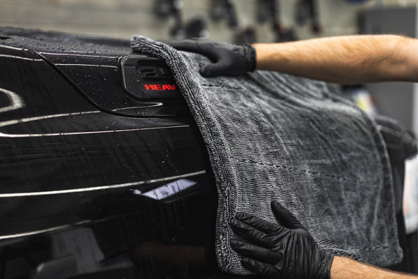The Liquid8r Heavy Metal M22 being used to dry off a black truck.