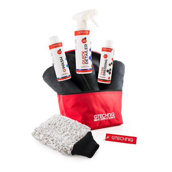 GTECHNIQ Smart Detail Kit featuring a red and black storage pouch, three white spray bottles, a gray microfiber cloth, and a small red tag on a white background.