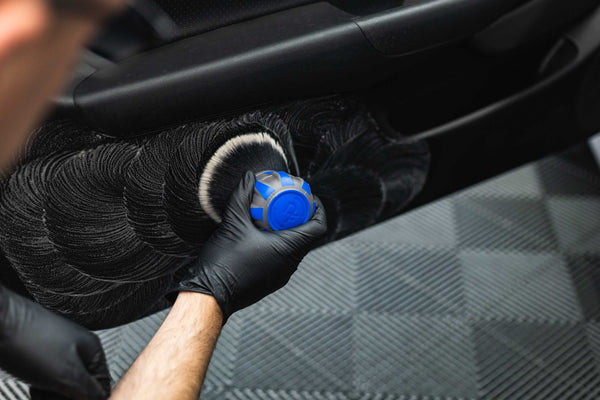 Person cleaning car door interior with a Detail Factory Curveball Avalanche.
