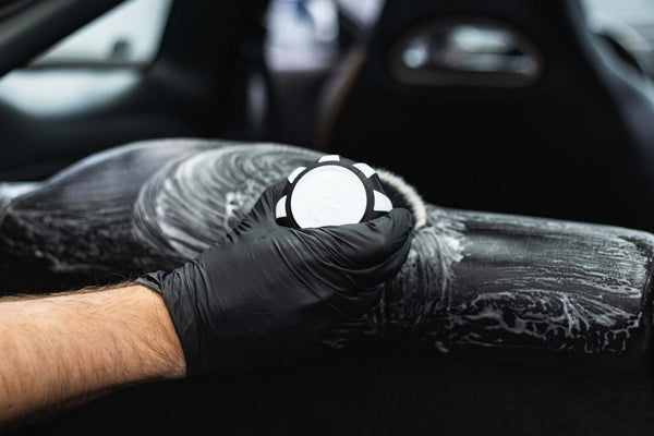 Person cleaning car interior with a Detail Factory Curveball Black Ice.