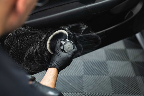 Person cleaning car door interior with a Detail Factory Curveball Grey.