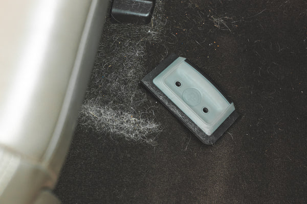 A Detail Factory Pet Hair Card laying next to a pile of pet hair that it cleaned.