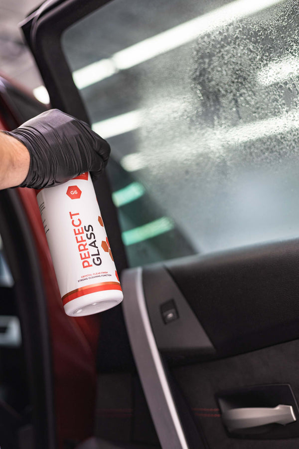 Gtechniq G6 Perfect Glass spraying on window of a car.