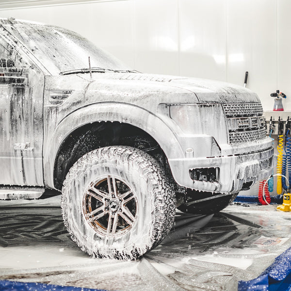 A black Ford Raptoer covered in Gtechniq Citrus foam.