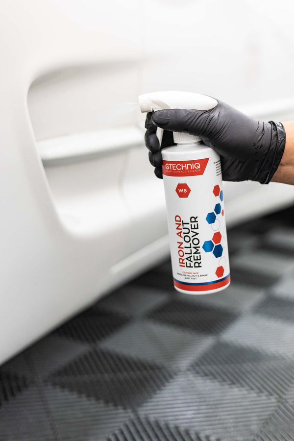 Gtechniq W6 Iron and Fallout Remover sprayed onto bottom part of white door panel of a Ford Explorer.