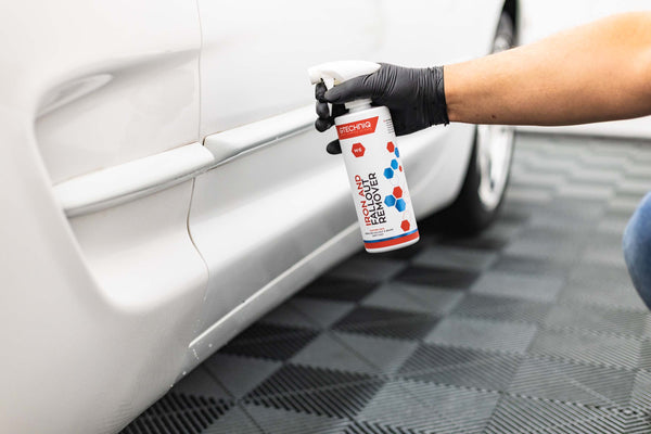 Gtechniq W6 Iron and Fallout Remover sprayed onto bottom part of white door panel of a Ford Explorer.