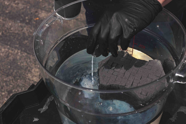 Koch-Chemie Rapid Rinseless Wash poured in cap and poured into a bucket with sponge.