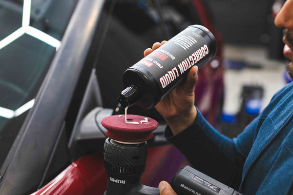 P&S Rehab being poured onto a maroon polishing pad connected to a rupes polisher.