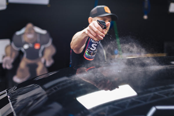 P&S Triple S being sprayed by a man on the roof of a vehicle.