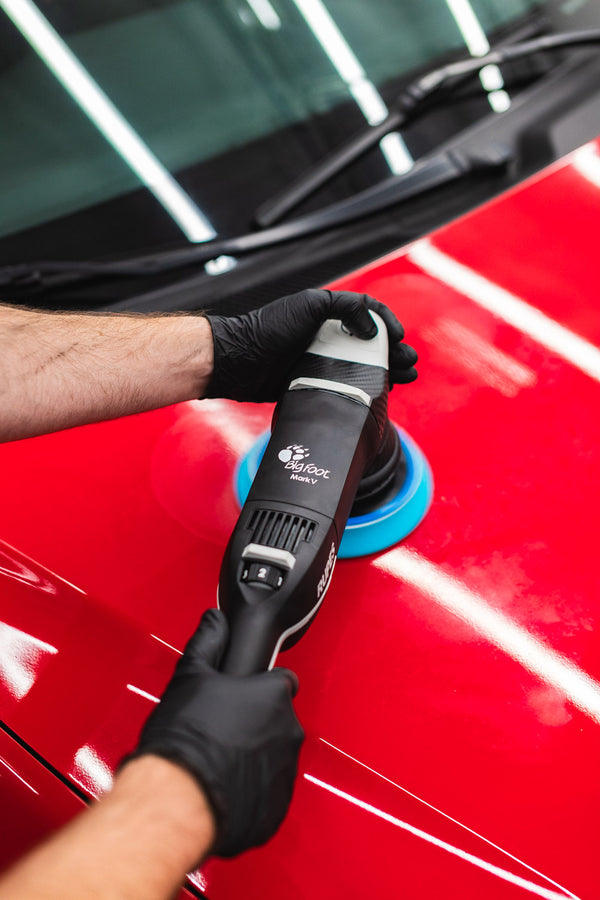 Rupes LHR Mark V polishing the hood of a vehicle.