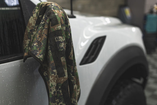 Slim Dryer in the color "Digital Camo" hanging off the side mirror of a White Ford Raptor.