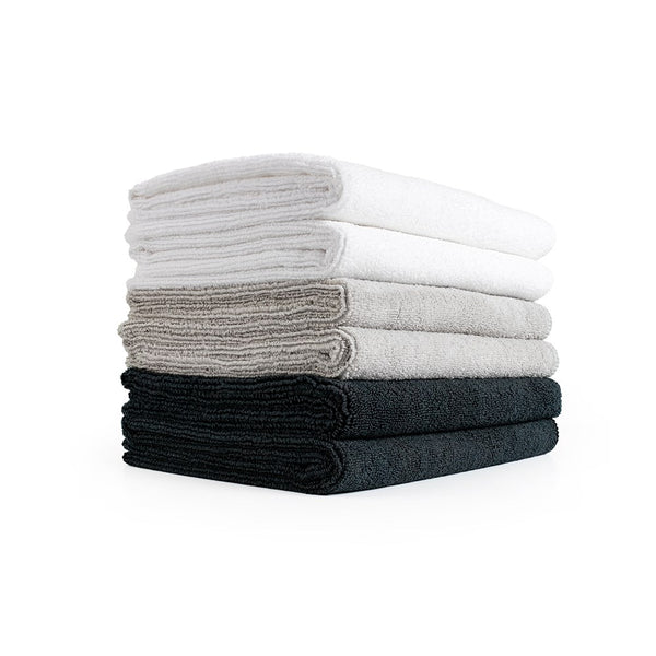 A stack of Spa and Sport towels on a white background.