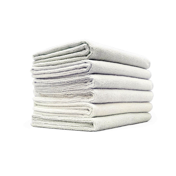 A stack of grey Spa and Workout towels on a white background.