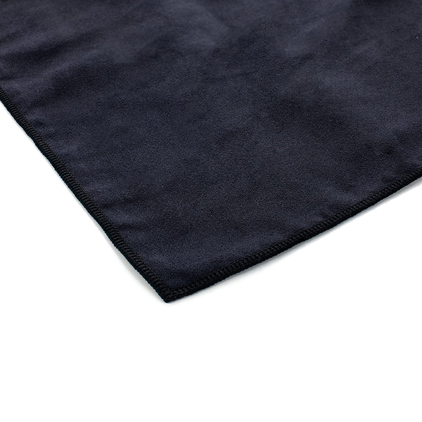 A black suede cloth corner on a white background.