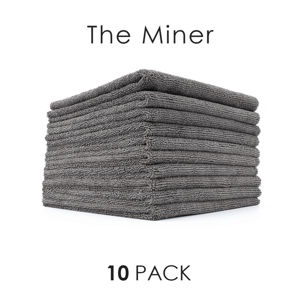 A stack of grey Miner towels with the text "10 Pack" on a white background.