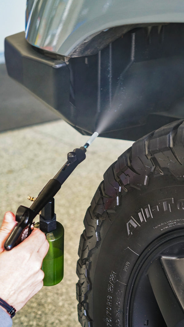 A demo of someone using The Rag Company Ultra Air Spray Applicator to clean the inside of a car wheel well.