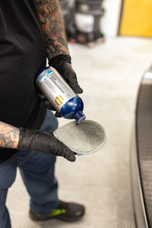 A person adding a Koch Chemie Cleaner to a TRC Ultra No Soak Round Detailing Applicator.