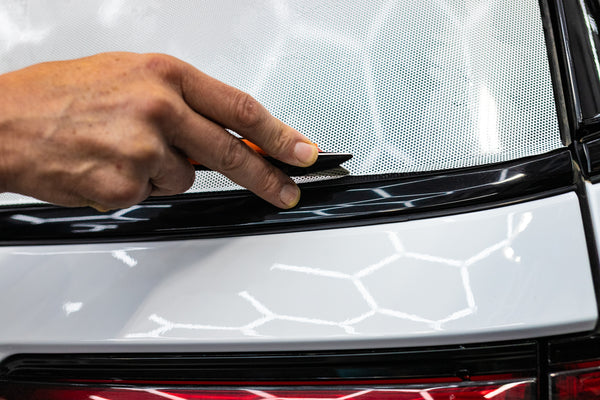 A person using the Yellotools Yelloguide Flexi on the frame of a vehicle.
