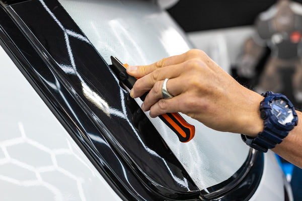 A person using the Yellotools Yelloguide Flexi on the frame of a vehicle.