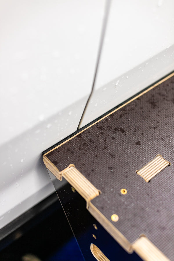 A close up of the Wrap Step leaning against the door of a white vehicle.