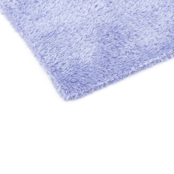 The corner of a single lavender Eagle Edgeless 350 16x16 towel from The Rag Company