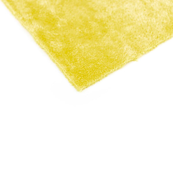 A corner of a single yellow Eagle Edgeless 350 16x16 towel from The Rag Company