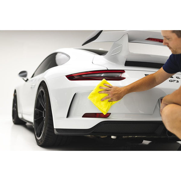 Using a yellow Eaglet 350 16x16 towel from The Rag Company to clean the rear of a Porsche 911 GT3