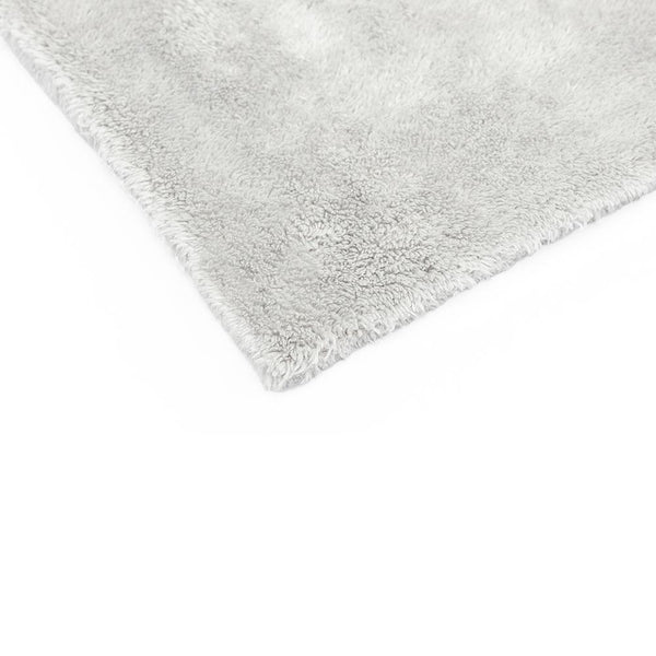 The corner of an Ice Grey 16x16 Eagle Edgeless Towel from The Rag Company. Having no edges or tags prevents scratching paint or glass.