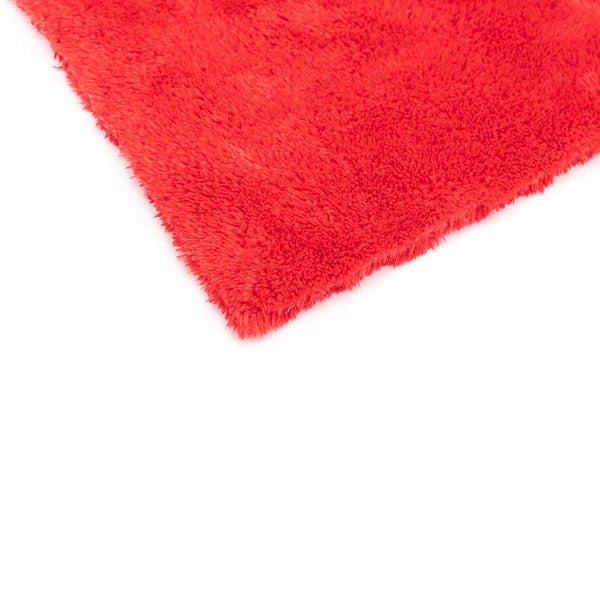 The corner of an Orange 16x16 Eagle Edgeless Towel from The Rag Company. Having no edges or tags prevents scratching paint or glass.