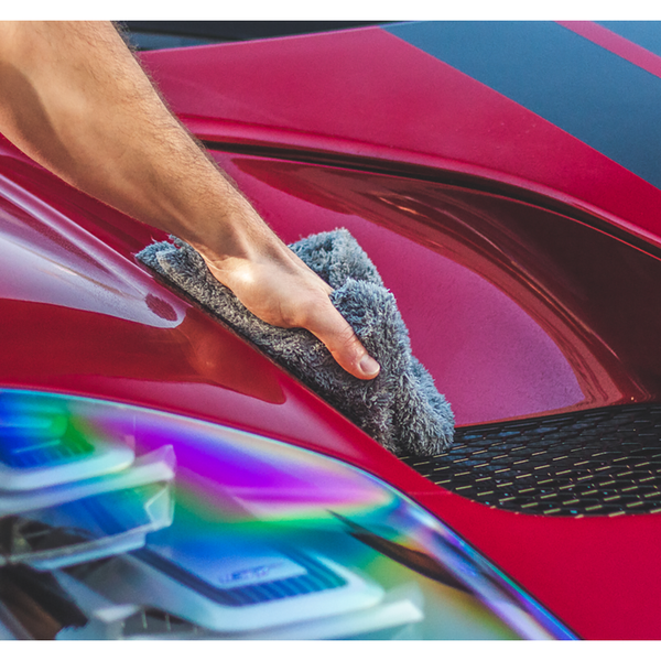 Using a grey Eagle Edgeless 600 towel to detail the exterior of a red Ford GT