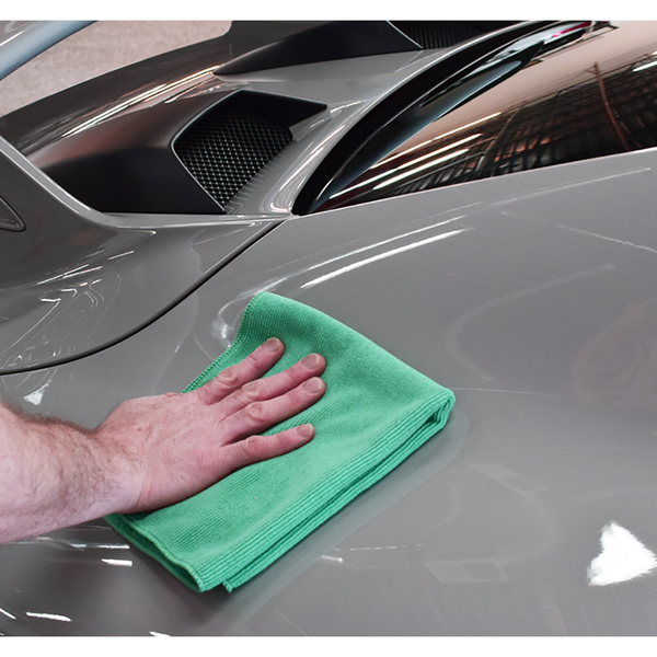 The Rag Company The Pearl Green towel wiping off a car.