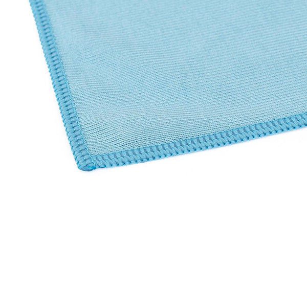 The corner of a blue glass towel on a white background.