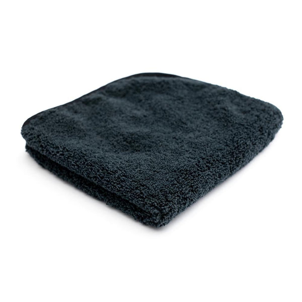 A black folded Spectrum 420 towel on a white background.