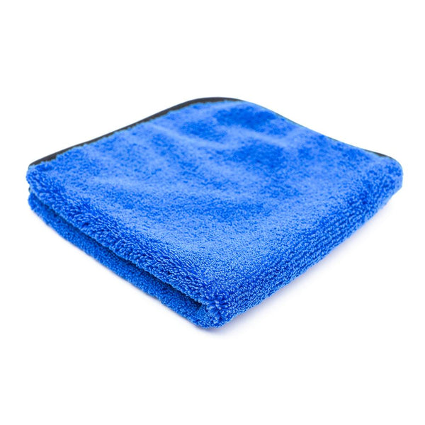 A folded blue Spectrum 420 towel on a white background.
