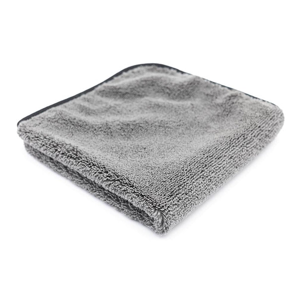A folded grey Spectrum 420 towel on a white background.