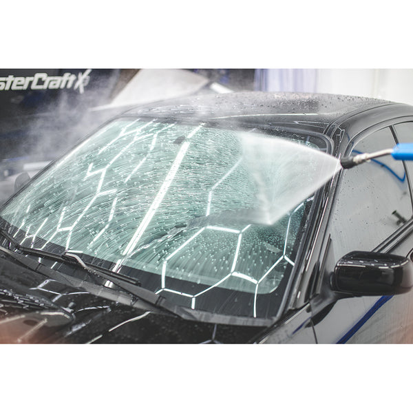 Showing how Gtechniq's Water Repellent Coating for Glass and Perspex causes water to bead and run off of the windshield of a black 2004 Subaru WRX STI