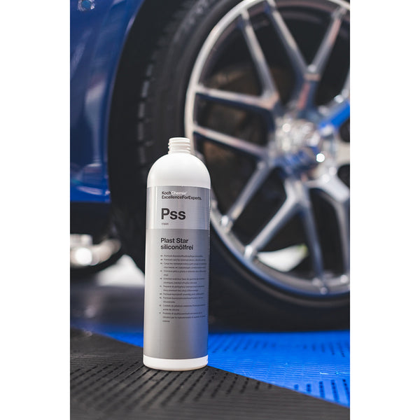 A bottle of Koch Chemie Plast Star Siliconolfrei with a car tire on a blue car in the background.