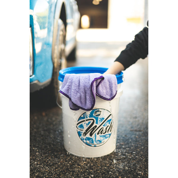 The Rag Company Minx Royale purple towel in a water bucket demo.