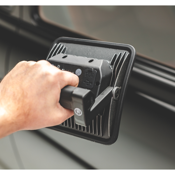 A closeup of a person holding the handle of a Scangrip Multimatch