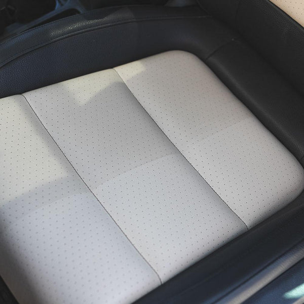 A before and after using P & S Terminator on a leather seat. The left side of the seat is a dusty grey and the right is a true grey.