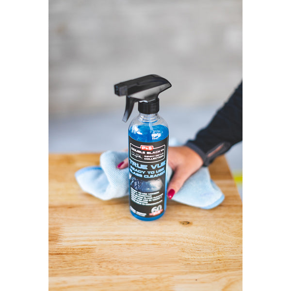 A spray bottle of P & S True Vue on a butcher block counter top.