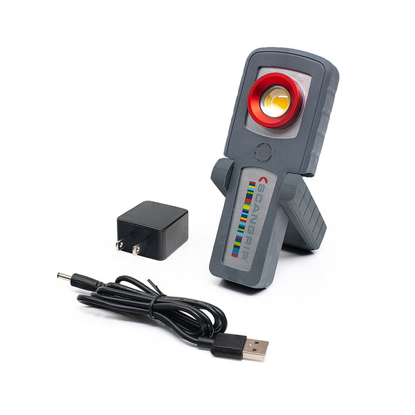 A Scangrip, charging cord, and wall charger on a white background.