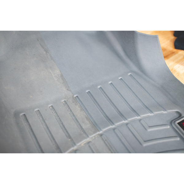 A before and after cleaning of a grey floor matt.