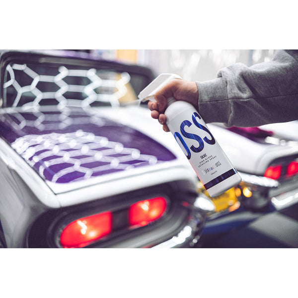 A closeup of a person spraying a purple car with Stjarnagloss Silke.