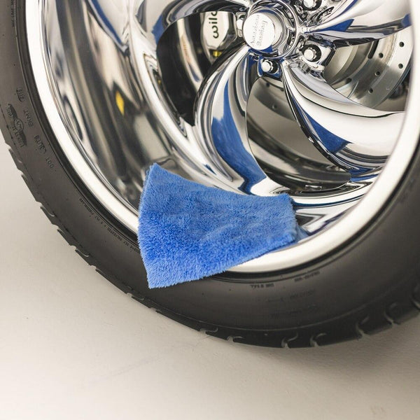 The Rag Company Eaglet 500 Towel laying on tire.