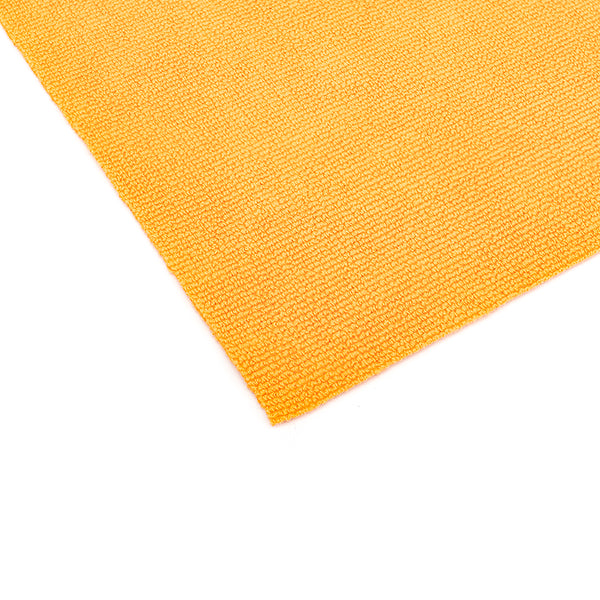 A close up of the edgeless border and corner of an orange Edgeless Pearl microfiber towels from The Rag Company.