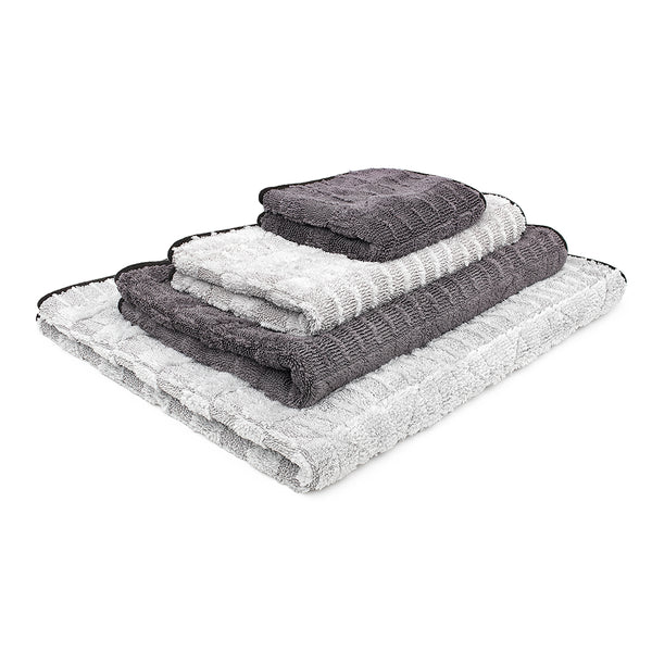 An image of the various sizes of The Gauntlet towel from The Rag Company. The towels come in the following sizes: 12 inches by 12 inches, 15 inches by 24 inches, 20 inches by 30 inches, and 30 inches by 36 inches. These towels are Ice Grey on One side and Gauntlet Grey on the other with a scratcheless suede edge banding them together