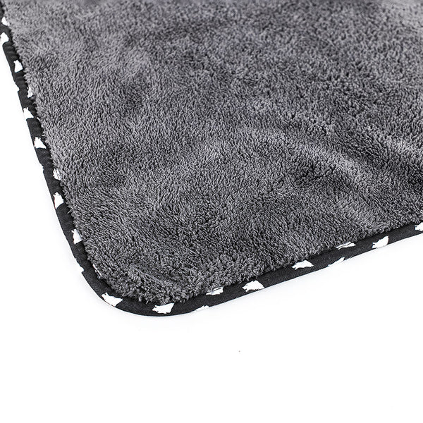 The corner of the dark grey wolfpack towel on a white background.