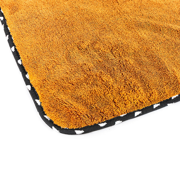 The corner of the brown wolfpack towel on a white background.